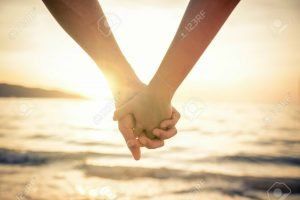 40823041-couple-of-lovers-holding-their-hands-at-a-beautiful-sunset-over-the-ocean-newlywed-couple-on-a-roman-stock-photo1-couple 3